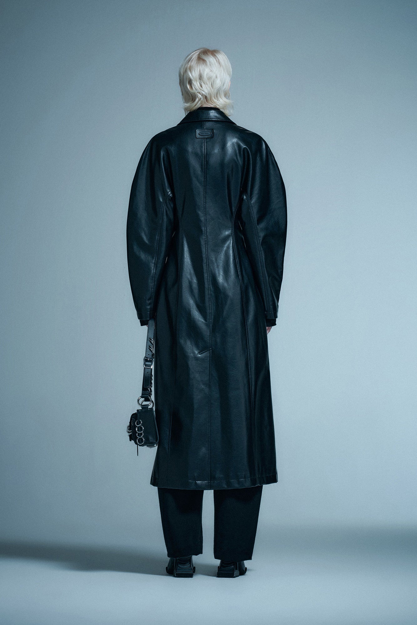 Long coat with curved sleeves and waist